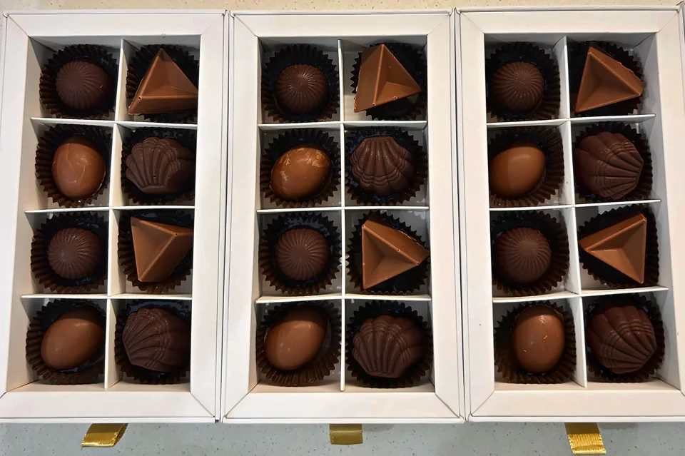 Three open Cioccolato Aurea gift boxes of handmade filled chocolates
